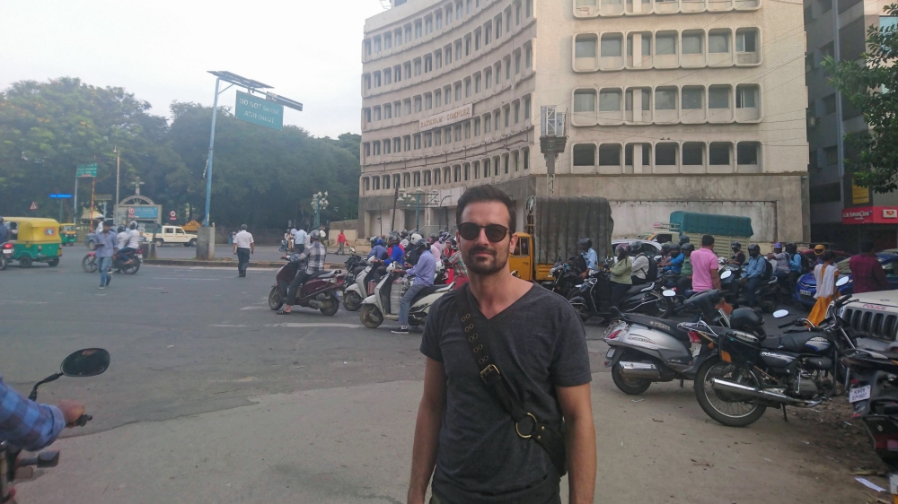 Posing in front of what it seems to be a Brutalist building in Bangalore.
