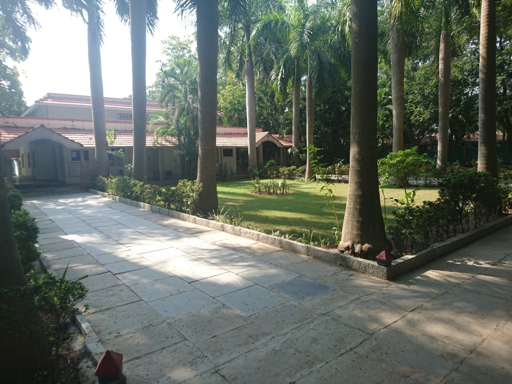 The men’s meditation hall and the immaculate main garden of the Dhamma Setu Centre.